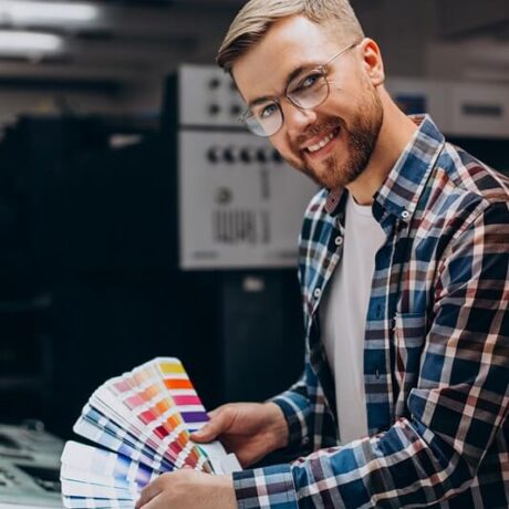 man-working-printing-house-with-paper-paints